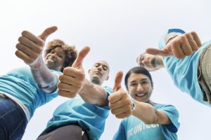 A group of people showing thumbs up because a seamless business relocation is possible and achievable.